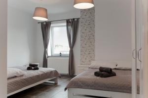 Postel nebo postele na pokoji v ubytování Apartamenty w Starym Browarze 3