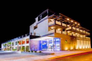 a building with a lit up facade at night at ApartHotel Playa Oliva in Oliva