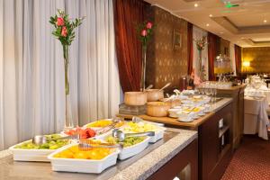 a buffet line with many plates of food at Hotel Plaza San Francisco in Santiago