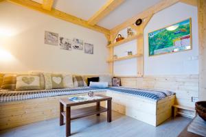 a room with a wooden couch and a table at Chopok Juh Apartman Horec in Tale