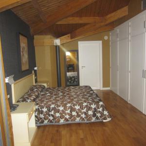 a bedroom with a bed and a wooden floor at Hotel Iru-Bide in Lumbier