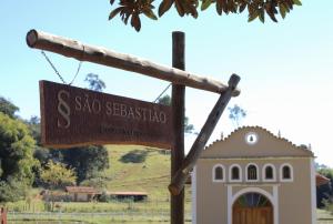 a sign for a sao sebastiao in front of a house at Pousada São Sebastião in São Sebastião do Rio Verde