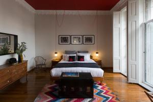 a bedroom with a bed and a table in it at El Patio 77 B&B in Mexico City