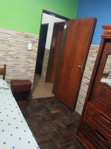 a large wooden door in a room with a bed at Casa centrica Luján in Luján +32 photos