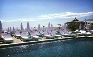 a group of lounge chairs next to a swimming pool at DeSilva Studios 46 & 47 in Mamaia