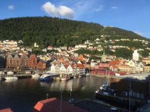 a city with a harbor with boats in the water at Apartment with Beautiful View to Bryggen in Bergen