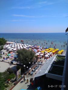 a crowd of people on a beach with umbrellas at Studio Just On The Beach in Paralia Katerinis