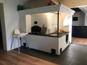 a kitchen with a stove in the middle of a room at Bjärkas Golf & Country Club in Nivelax