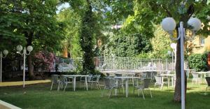 a group of tables and chairs in a park at Appart Hotel Corte HR in Corte