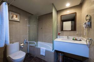 a bathroom with a sink and a toilet and a tub at Boudl Al Rass in Ar Rass +12 photos