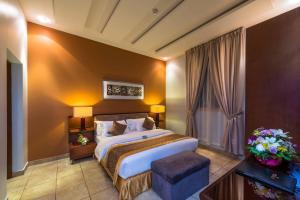a hotel room with a bed and a window at Boudl Al Fakhria in Unayzah +20 photos