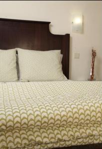 a bedroom with a large bed with a wooden headboard at Hotel Palanca in Porto