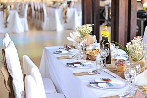 a white table with plates and wine glasses on it at Complex HAMAK in Iaşi