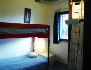 a bedroom with a bunk bed and a window at Cottage Fuile 'E Mare in Orosei