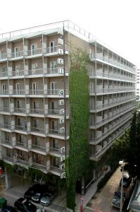 a large apartment building with a ivy growing on it at Queen Olga Hotel in Thessaloniki