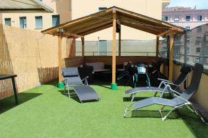 a gazebo with chairs and a table on a balcony at Hotel Pyramid in Rome