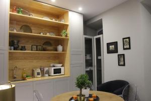 a dining room with a table and a microwave at Guest House Santa Clara in Coimbra