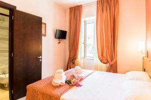 Postel nebo postele na pokoji v ubytování Hotel Tenda Rossa