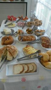 a table with many different types of food on it at Hotel Nardy in Alvinópolis