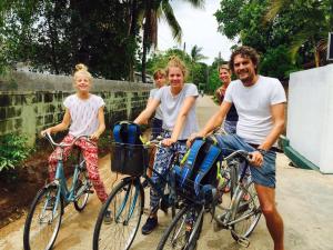 a group of people on bikes and a man at Sanctuary Cove Guest House in Polonnaruwa