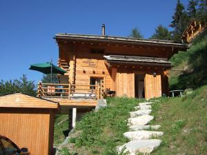 a log cabin with a path leading to it at Chalet Chaperon Rouge in Nendaz
