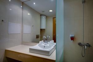 a bathroom with a sink and a shower at Effect Malina Residence Hotel in Pamporovo +21 photos