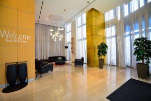 a lobby with a welcome sign in a building at Sea Breeze Apartment in Bat Yam