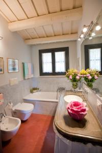 a bathroom with a sink and a toilet and a tub at Baglio Sant'Andrea in Valderice