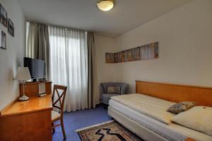 Postel nebo postele na pokoji v ubytování Hotel Maxim