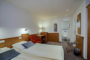 Postel nebo postele na pokoji v ubytování Hotel Maxim
