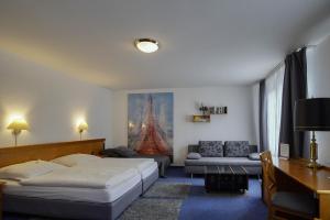Postel nebo postele na pokoji v ubytování Hotel Maxim