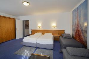 Postel nebo postele na pokoji v ubytování Hotel Maxim