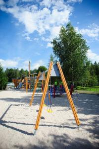 a playground with a slide in a park at Gamtos Perlas in Karklė