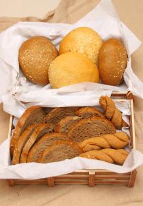 two baskets filled with different types of bread at Saint Constantine Hotel in Kos