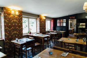 a restaurant with wooden tables and chairs in a room at The Maltsters Arms in Totnes