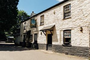 an old stone building with a sign on it at The Maltsters Arms in Totnes