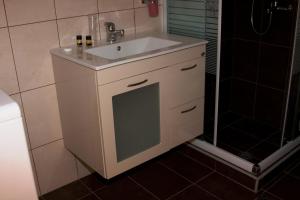 a bathroom with a white sink and a shower at Thea Hotel in Marmari +56 photos