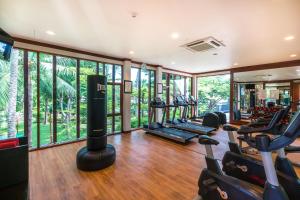 a gym with a bunch of treadmills and ellipticals at NH Collection Samui Peace Resort in Bophut