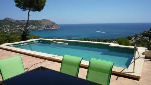 a swimming pool with a view of the ocean at Traumvilla Encina in Canyamel