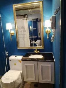a bathroom with a sink and a mirror and a toilet at 1 Day Car Hotel Station 18 in Ipoh