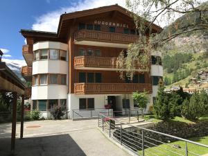 a large apartment building with a balcony at Chalet Guggenbiel in Zermatt