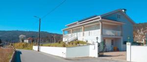 a large white house on a street at Casa do Lavrador in Casal