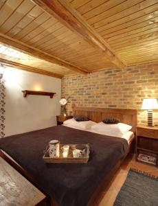 a bedroom with two beds and a brick wall at Apartments Ivica i Marica in Karanac