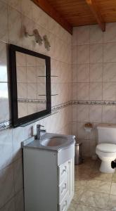 a bathroom with a sink and a toilet at Hostal Casa Amarilla San Vicente de Tagua Tagua in San Vicente de Taguatagua