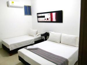 Postel nebo postele na pokoji v ubytování Hotel Central