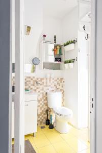 a bathroom with a white toilet in a room at Party Zone in Lisbon