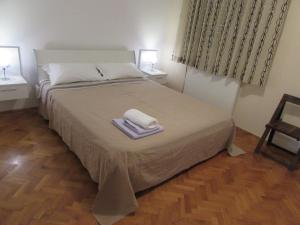 a bedroom with a bed with two towels on it at Apartment Ana in Krnica