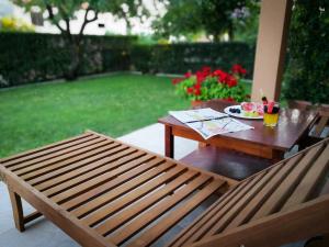 a wooden table and bench with a plate of food on it at Premium Apartments Tade Funtana in Funtana