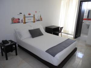 Ένα ή περισσότερα κρεβάτια σε δωμάτιο στο Hotel Cosmos Sincelejo