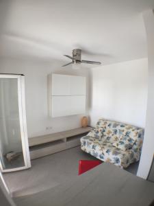 a living room with a chair and a mirror at La casa del Tramonto in Praia a Mare